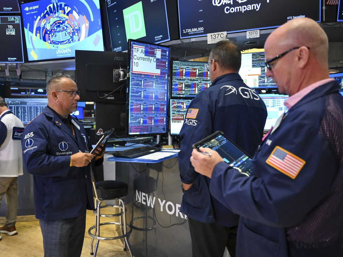 Traders work on the floor of the New York Stock Exchange (NYSE) at the opening bell in New York on July 27, 2026.