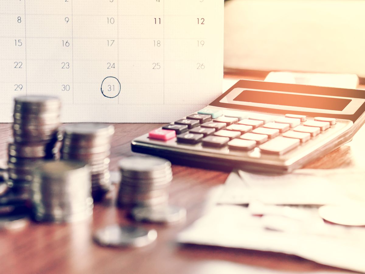 debt collection and tax season concept with deadline calendar remind note,coins,banks,calculator on table, background ,time to pay concept