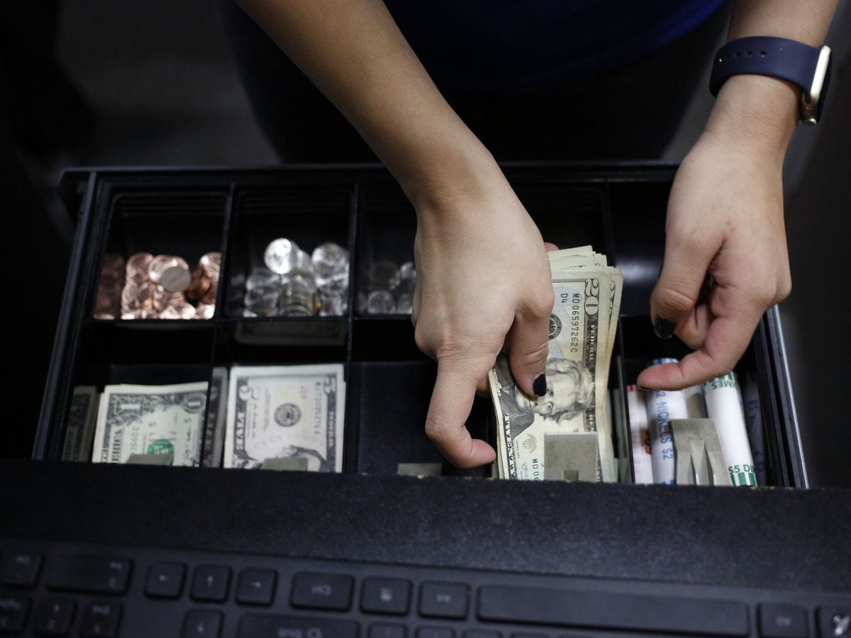 A cashier handles a cash register at a Best Buy Co. store in Louisville, Kentucky, U.S., on Thursday, Nov. 23, 2017