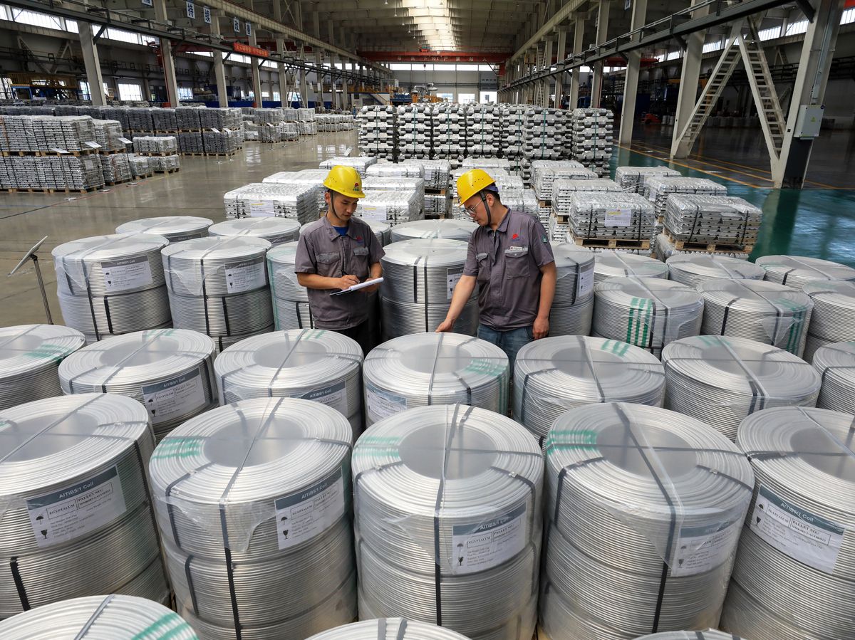 Workers supervise rolls of aluminum-titanium-boron, a core auxiliary material for aluminum-based products, at Anhui Dongbo Shengye New Materials Technology in Huaibei, eastern China's Anhui province on August 22, 2026