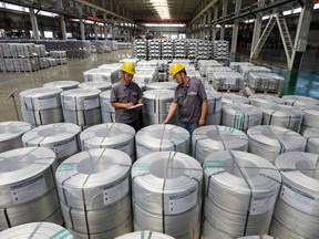 Workers supervise rolls of aluminum-titanium-boron, a core auxiliary material for aluminum-based products, at Anhui Dongbo Shengye New Materials Technology in Huaibei, eastern China's Anhui province on August 22, 2026