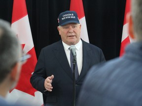 Ontario Premier Doug Ford wears a 'Canada is not for sale' hat to meetings with the country's premiers in Ottawa.
