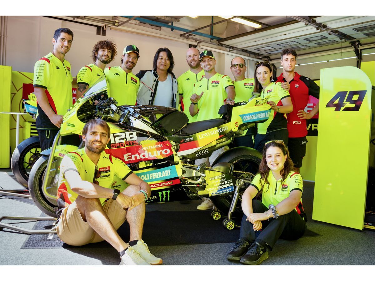 Hollywood actor Sung Kang joins the Pertamina Enduro VR46 Racing Team in the MotoGP garage, alongside the team's race bike featuring 12B SPORTS branding.