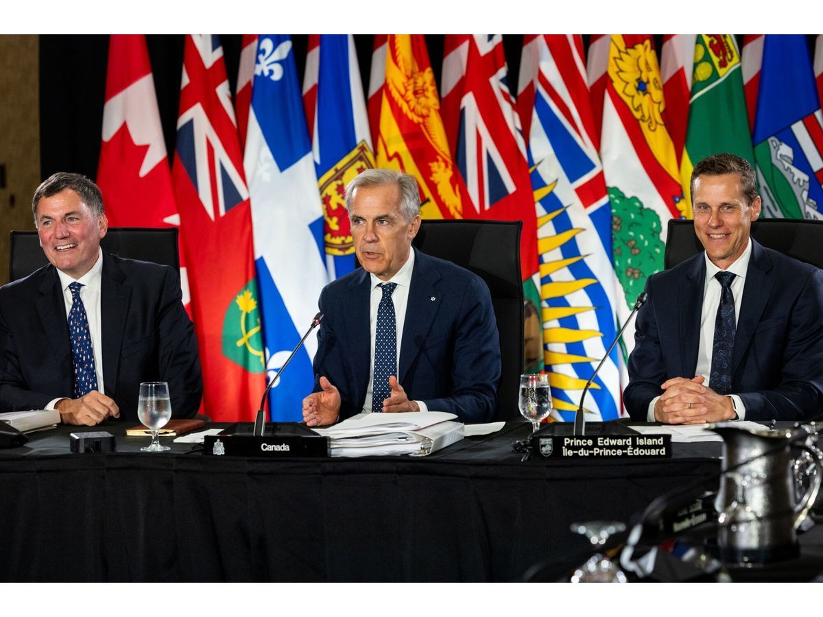 Prime Minister Mark Carney, center, and Canada-US Trade Minister Dominic LeBlanc, left, speak to Canada's provincial leaders at a meeting last month.