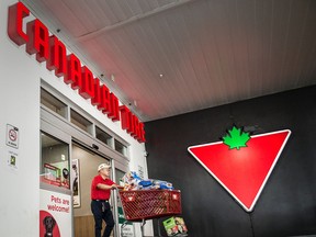 A shopper leaves a Canadian Tire in Toronto. Retail sales in Canada increased in June.