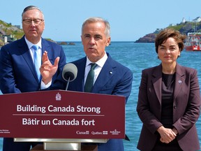 Prime Minister Mark Carney, along with Newfoundland and Labrador Premier Tony Wakeham and Quebec Premier Christine Fréchette, speaks at an announcement for a new MOU on the Churchill Falls and Gull Island hydro-electric projects on Monday.