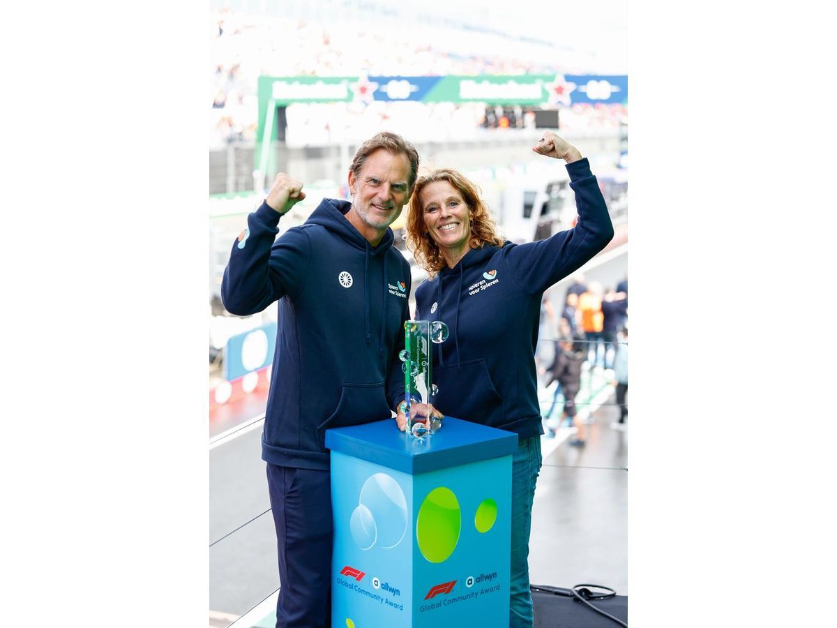 The F1® Allwyn Global Community Award 2026 trophy presented to Monique Maks (Director) and Ronald de Boer (former footballer and ambassador) of winning local charity Spieren voor Spieren at the FORMULA 1® HEINEKEN DUTCH GRAND PRIX 2026 in the Netherlands.