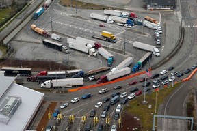 Tractor trailers and private vehicles entering the US from Canada at the Pacific Highway Border Crossing in Blaine, Washington.