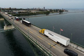 Tractor trailers and vehicles cross the Peace Bridge at the Canada-United States border in Fort Erie, Ontario on Aug. 20.