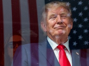 Donald Trump watches the NTT INDYCAR Series Sunday in Washington. Monday the U.S. President threatened higher tariffs against Canada's auto industry.
