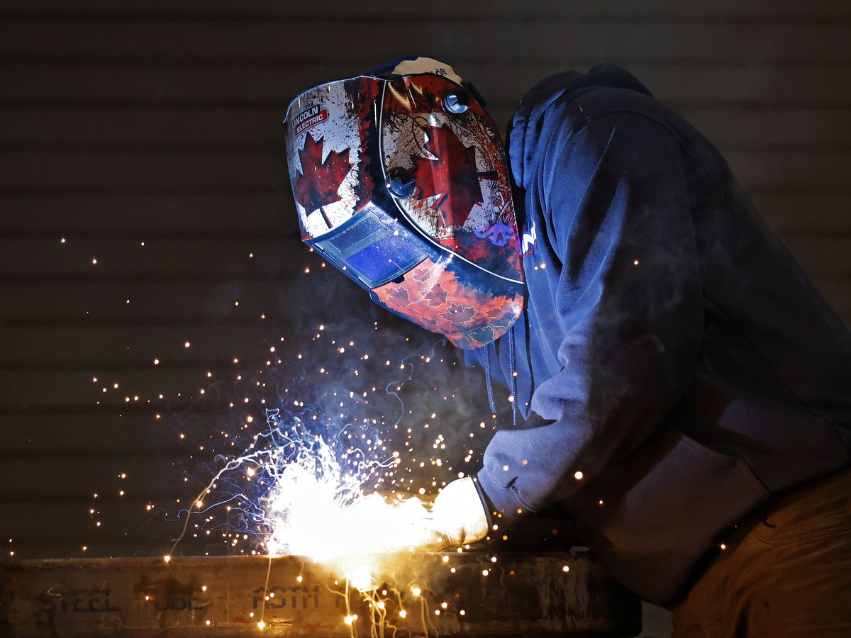 A worker welds a dump body cargo bed at a manufacturing facility in Vars, Ontario May 4, 2026