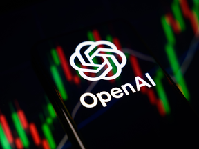 The OpenAI logo is displayed on a smartphone screen placed on a reflective surface onto which a stock market chart is projected, in Creteil, France, on June 9, 2026.