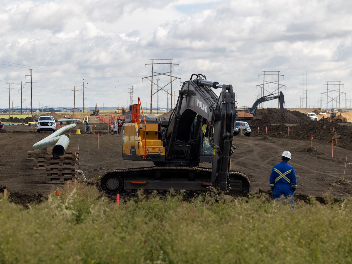 A worker and machinery can be seen at a construction site for Bell’s Artificial Intelligence (AI) Data Centre in Rural Municipality of Sherwood, Sask., on Wednesday, August 5, 2026.