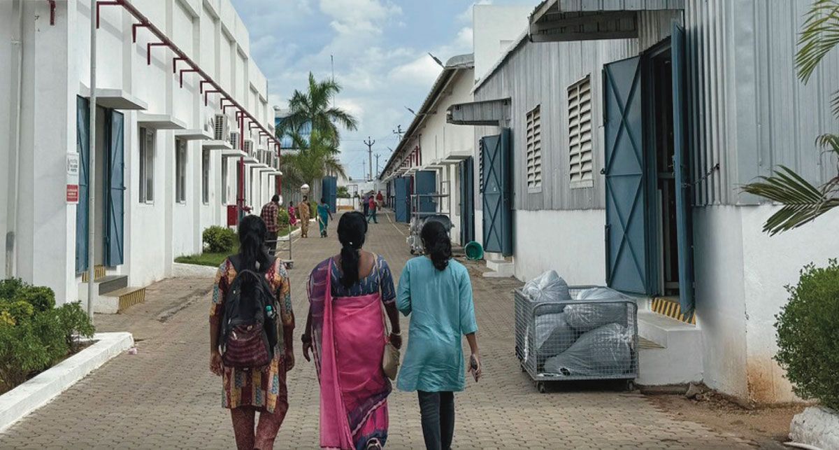 Women workers walk outside the Eastman Exports factory in Dindigul. Women workers walk outside the Eastman Exports factory in Dindigul.