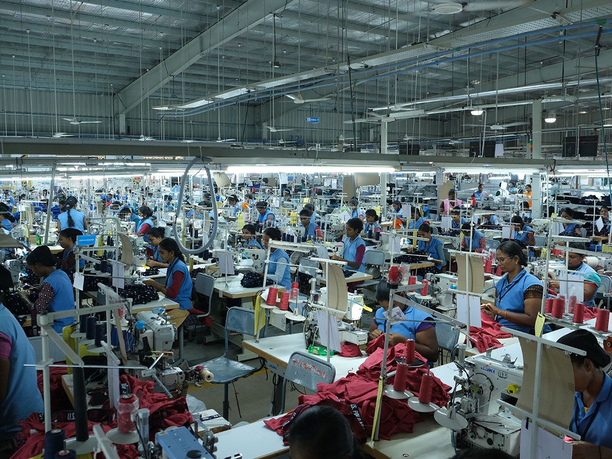 Women work on sewing machines at Eastman's Dindigul factory. Women work on sewing machines at Eastman's Dindigul factory.