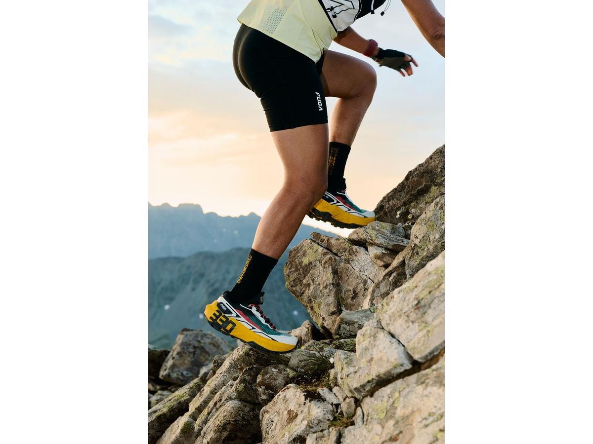 Athlete climbs wearing special-edition FUGA EX 330 TG in Aosta Yellow