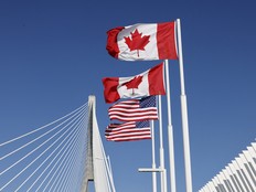 Flags of Canada and United States fly across the international border on the Gordie Howe International Bridge that connects Windsor, Ont., and Detroit, Michigan.