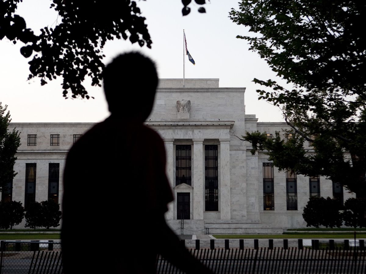 A man walks past the U.S. Federal Reserve building in Washington, D.C.