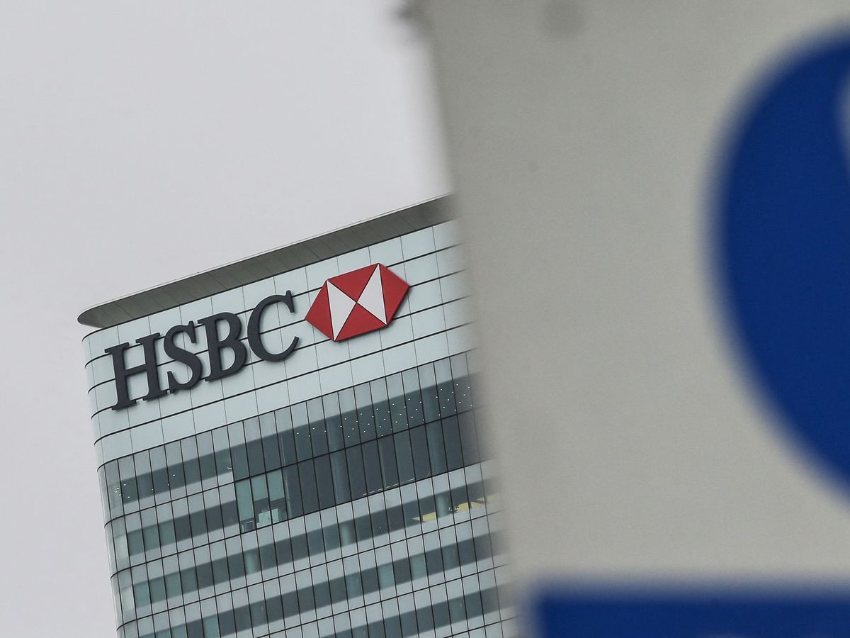 A sign is pictured in front of HSBC's London headquarters in the financial district Canary Wharf in London on February 21, 2017.