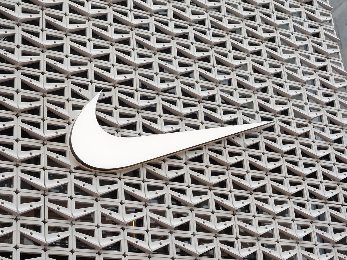 The Nike logo hangs above the entrance to the Nike store on December 21, 2021 in Miami Beach, Florida.