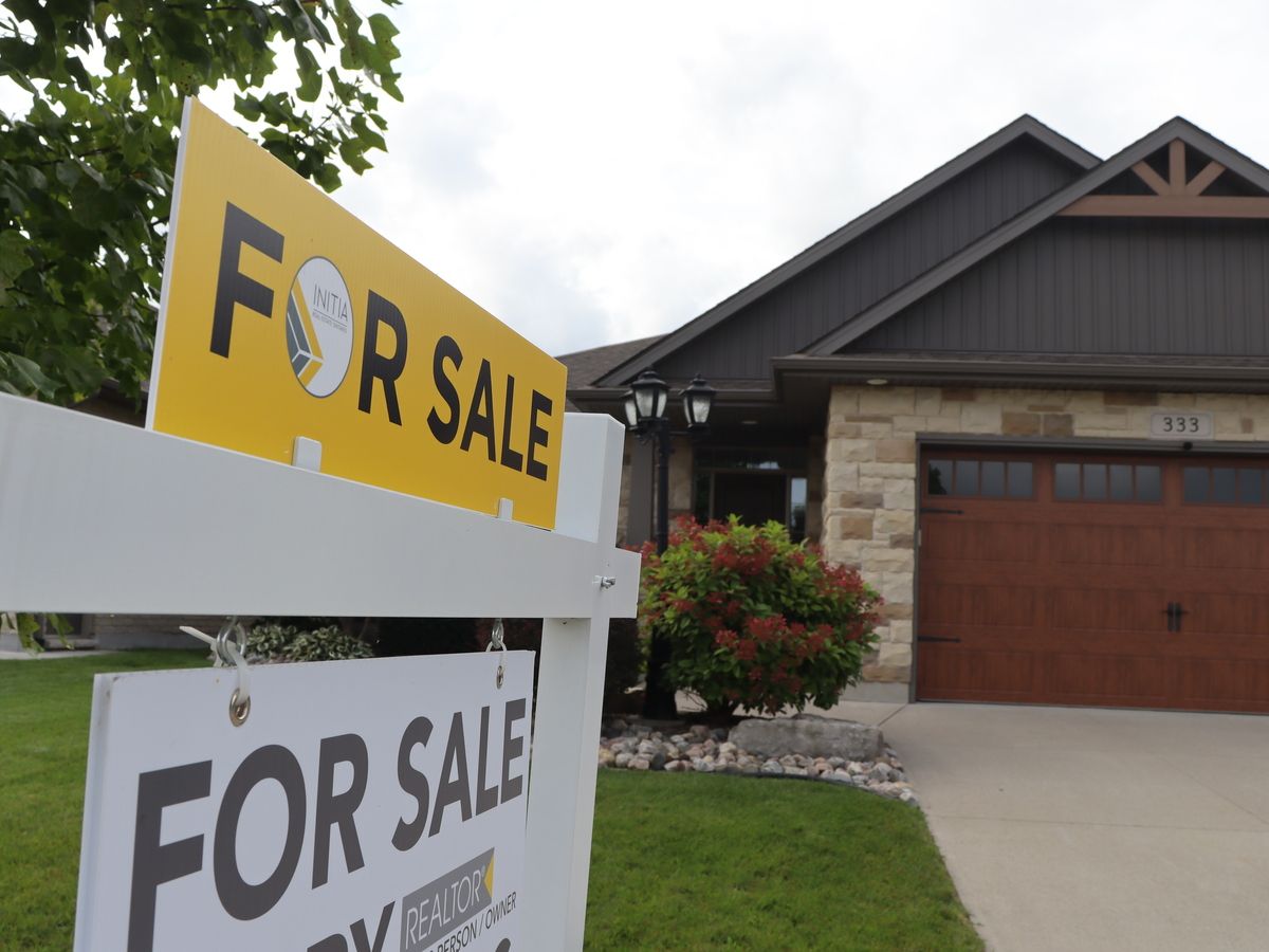 A for sale sign is shown outside a home in Sarnia.