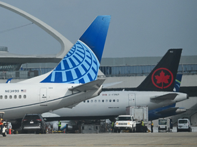 The Theme Building stands on the horizon as Alaska Airlines, United Airlines, and Air Canada aircraft sit parked at a terminal at Los Angeles International Airport (LAX) in Los Angeles on September 19, 2026.