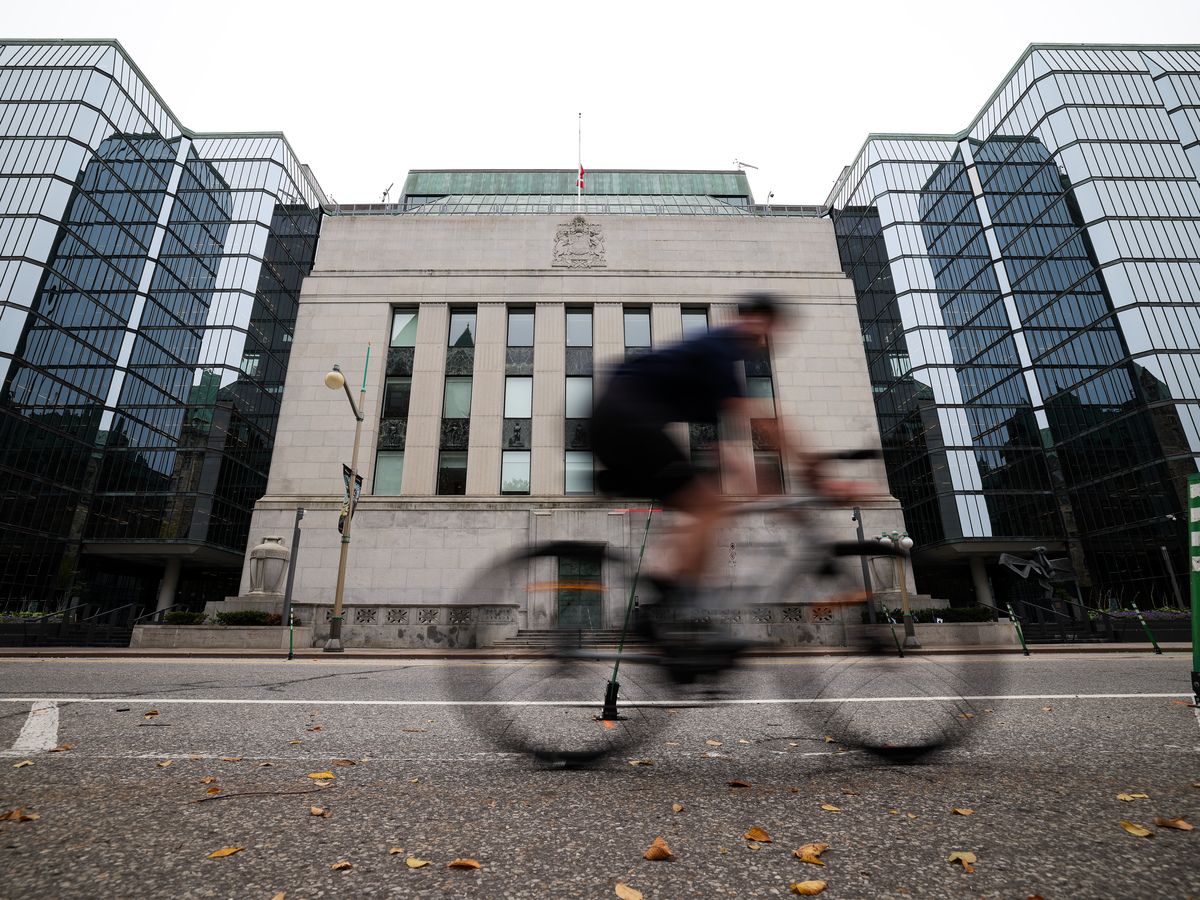 Cyclist is seen passing in front of Bank of Canada building in Ottawa on Sept. 30, 2026.