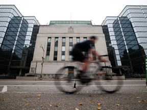 Cyclist is seen passing in front of Bank of Canada building in Ottawa on Sept. 30, 2026.