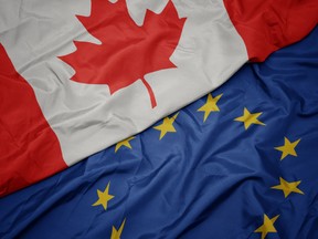 waving colorful flag of european union and flag of canada.