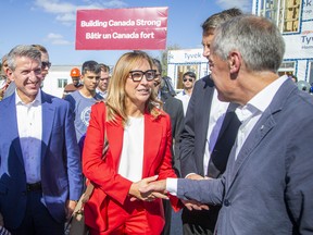 Ana Bailão, Chief Executive Officer of Build Canada Homes, greet the prime minister after the press conference Sunday.
