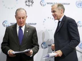 Special envoy to the United Nations for climate change Michael Bloomberg and Bank of England Governor Mark Carney (R) attend a press conference during the One Planet Summit at the Seine Musicale on the Ile Sequin on December 12 in Boulogne-Billancourt, France in 2017.
