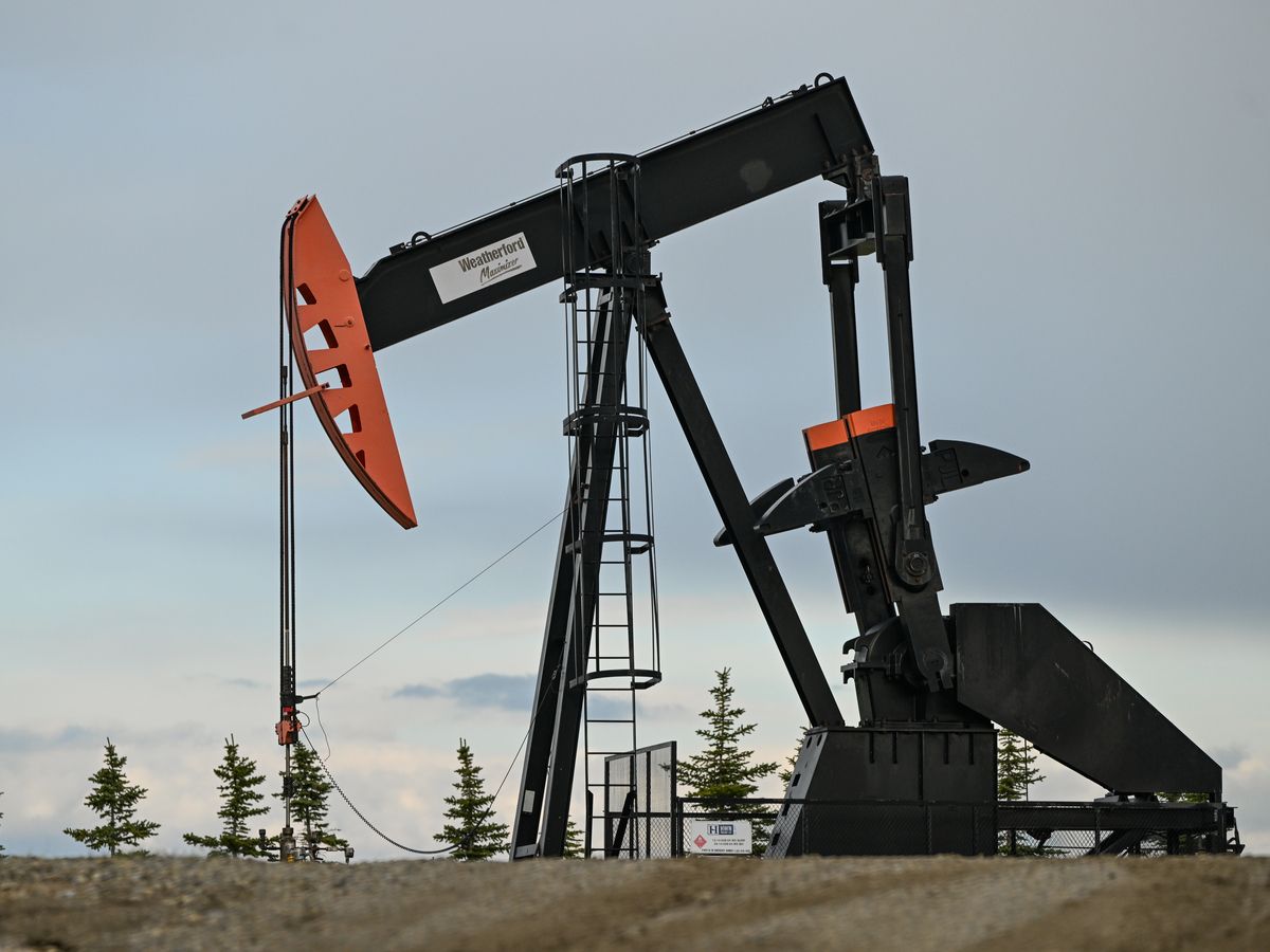 An oil well in a field seen along Highway 22, known as the Cowboy Trail, between Cochrane and Cremona, in Alberta, Canada on May 22, 2025.