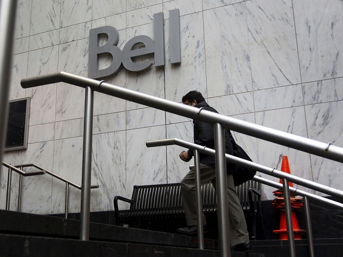 A pedestrian arrives at BCE Inc.'s Bell Canada office building in Toronto on Aug. 8, 2012.