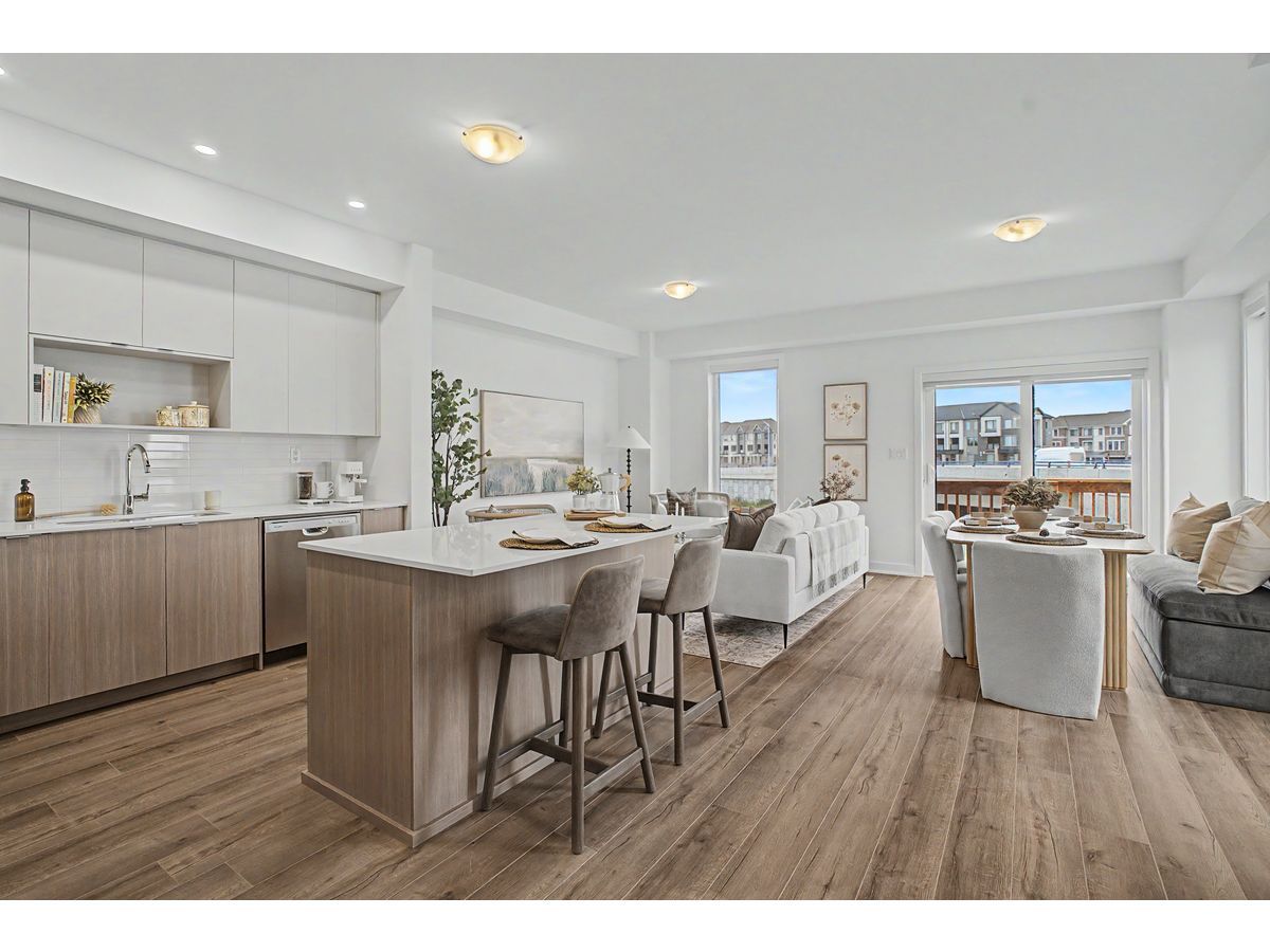 The open-concept kitchen and living area in a MPV Parkfield Towns model home showcases the spacious, family-oriented design found throughout the community's three- and four-bedroom rental townhomes, offering modern finishes and comfortable living spaces for everyday life and entertaining.