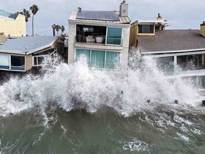 Houses pounded by waves