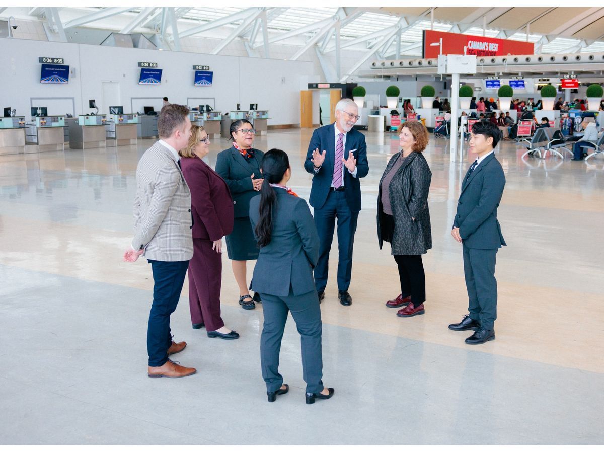 Seneca students and graduates speak with executives from Toronto Pearson and Seneca Polytechnic at Toronto Pearson International Airport's Terminal 1
