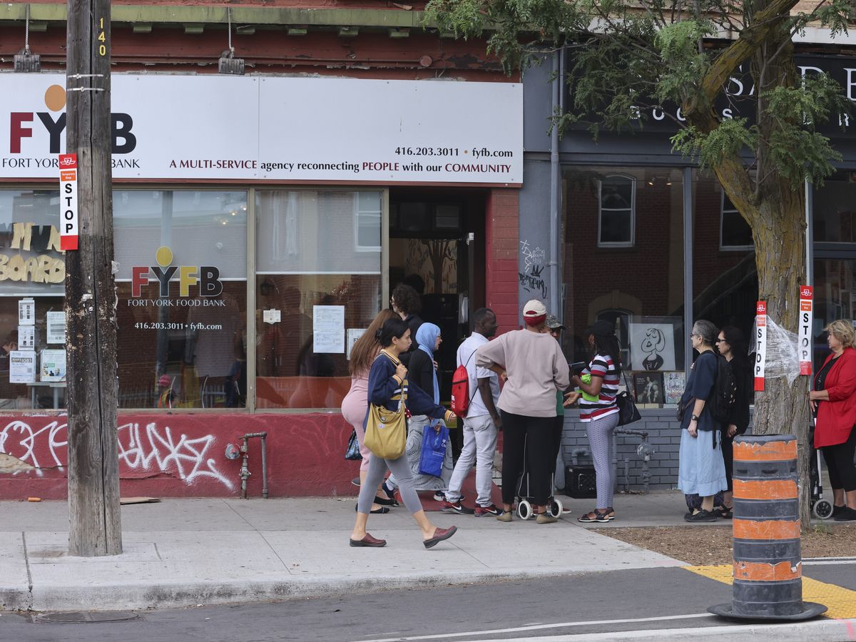 A crowd of people outside the Fort York Food Bank at 380 College St. in Toronto.