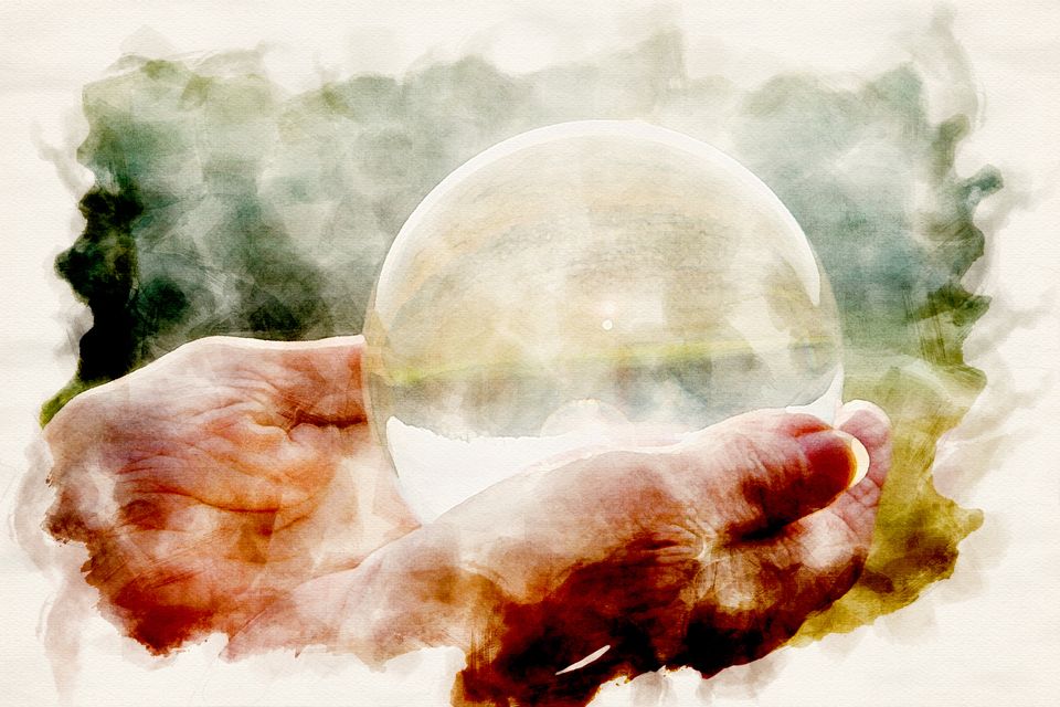 close-up of womans hand holding a shiny glass sphere in watercolors