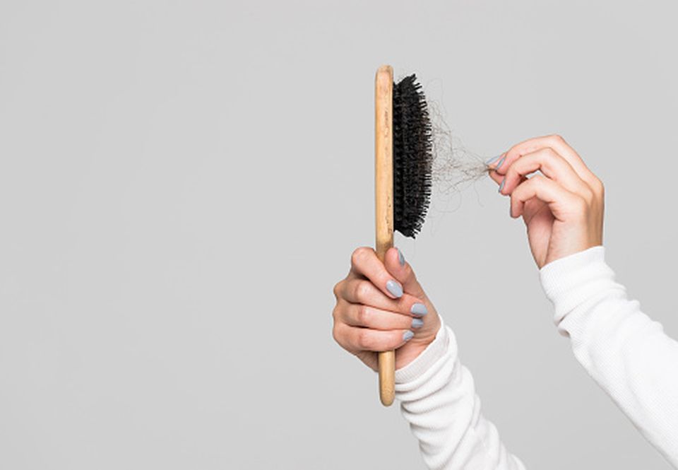 hair being pulled from a brush