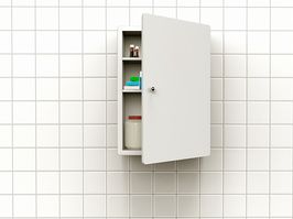 an open medicine cabinet on a white wall