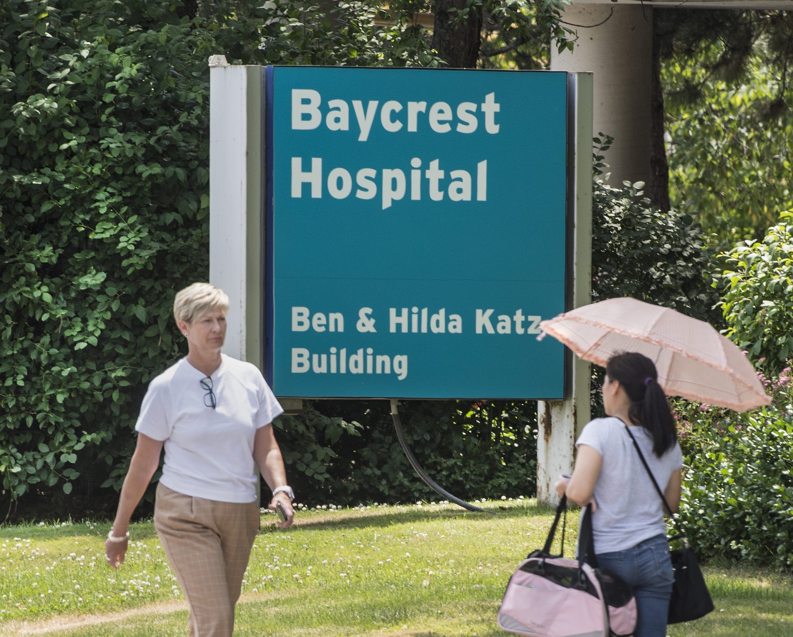 Pedestrians pass by Toronto's Baycrest Hospital 