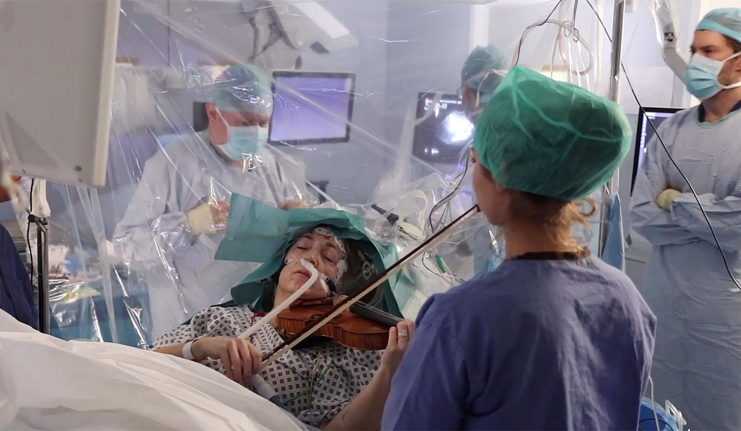 Musician Dogmar Turner playing the violin during brain surgery at King's College Hospital in London, UK.