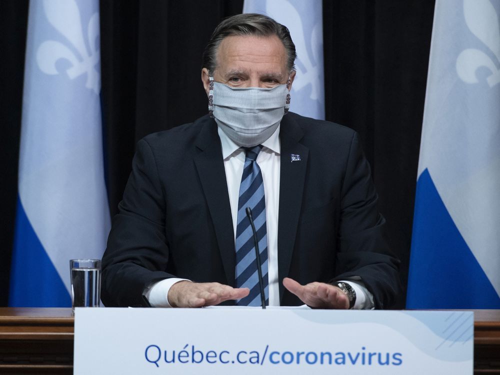 Quebec Premier Francois Legault arrives at a news conference on the COVID-19 pandemic wearing a mask, Tuesday, May 12, 2020 at the legislature in Quebec City.