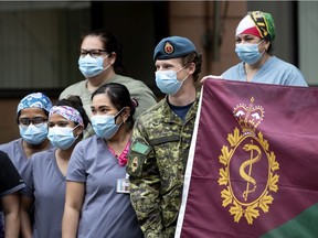 Staff pose during a ceremony marking the departure of soldiers from St-Andrew Residential Centre in N.D.G.