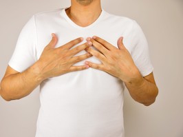 man with hands on chest