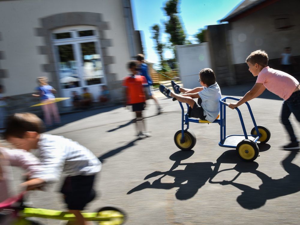Children play in a school playground on September 7, 2018.