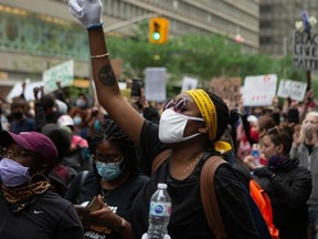 Demonstrators take part in a rally protesting the death of Regis Korchinski-Paquet in downtown Toronto, Saturday May 30, 2020. Korchinski-Paquet, 29, fell from the balcony of a 24th-floor Toronto apartment while police were in the home. Thousands of protesters took to the streets to rally in the aftermath of high-profile, police-involved deaths in both Canada and the United States
