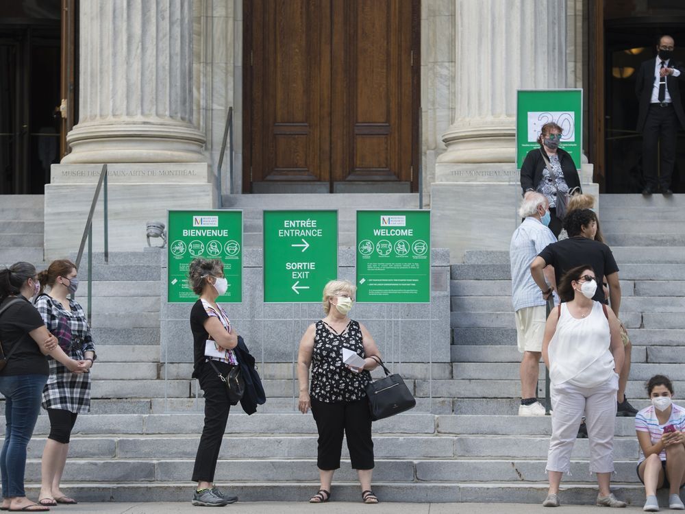 People wear face masks as they wait to enter the Museum of Fine Arts in Montreal, Saturday, June 6, 2020, as the COVID-19 pandemic continues in Canada and around the world. A new poll suggests Canadians are increasingly wearing protective face masks as they emerge from months of isolating at home to curb the spread of COVID-19.Graham Hughes / THE CANADIAN PRESS
