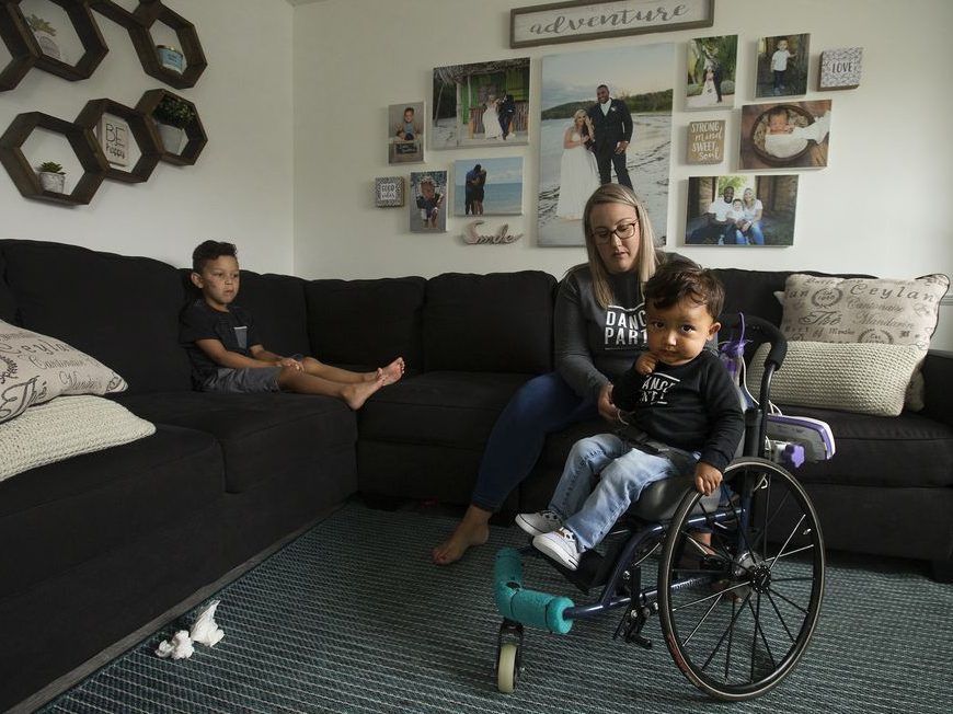 lana bernardin helps her son kaysen martin, 1, into the family living room, in edmonton thursday july 2, 2020. her oldest son blake martin, 4, is also pictured (left). kaysen has a rare motor neuron disease called spinal muscular atrophy type 1 (sma 1). his family has met all approvals to get a new drug called zolgensma administered to help keep martin alive and healthy, but it costs $2.8 million and isn't covered in alberta.