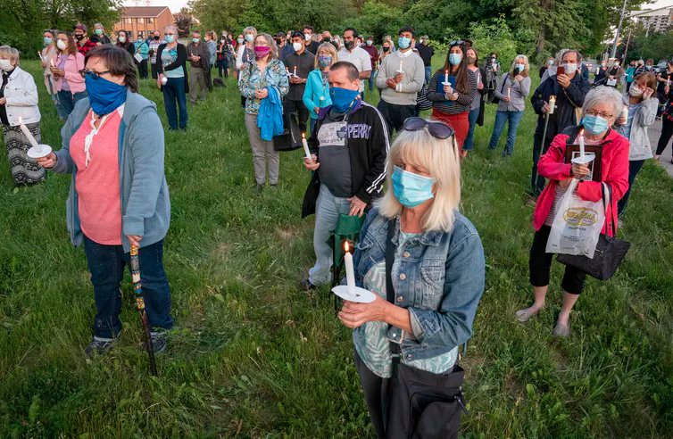 participants attend a vigil for covid-19 victims at the orchard villa long-term care home in pickering, ont. in june 2020. 